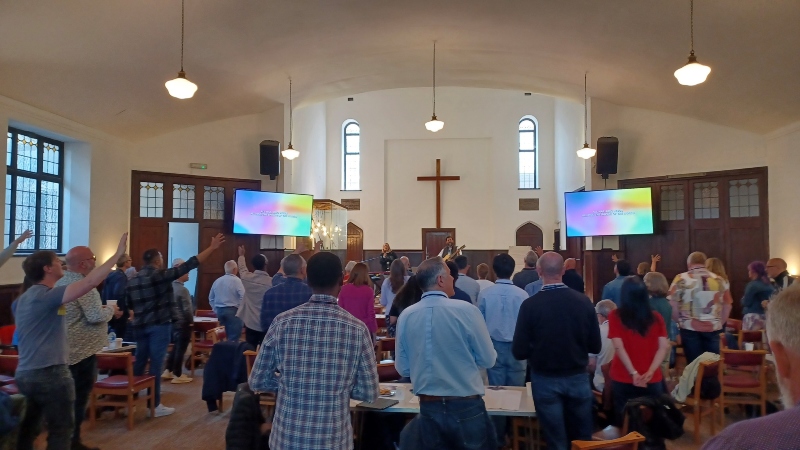 Everyone Everywhere at Kings Cross Baptist Church 23 May. People are engaged in sung worship, some with hands in the air. Picture taken from back of the church.