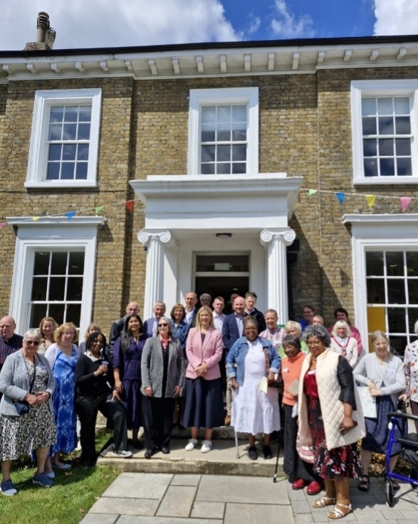 The Grove Centre Church in Sydenham refurbishment opening. A group of people stood outside the building, with MP Ellie Reeves in the centre