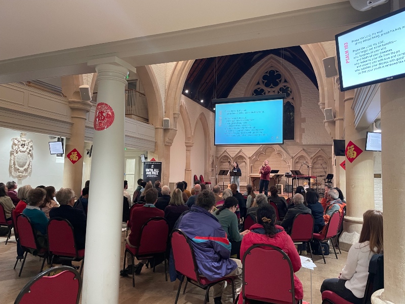 A church congregation gathered for a presentation and prayer session